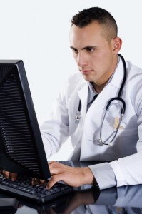 Male Doctor typing on computer
