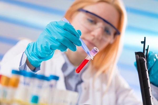 blonde female doctor analyzing blood sample