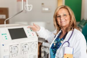 a female testosterone doctor showing how to use a dialysis machine  300x200