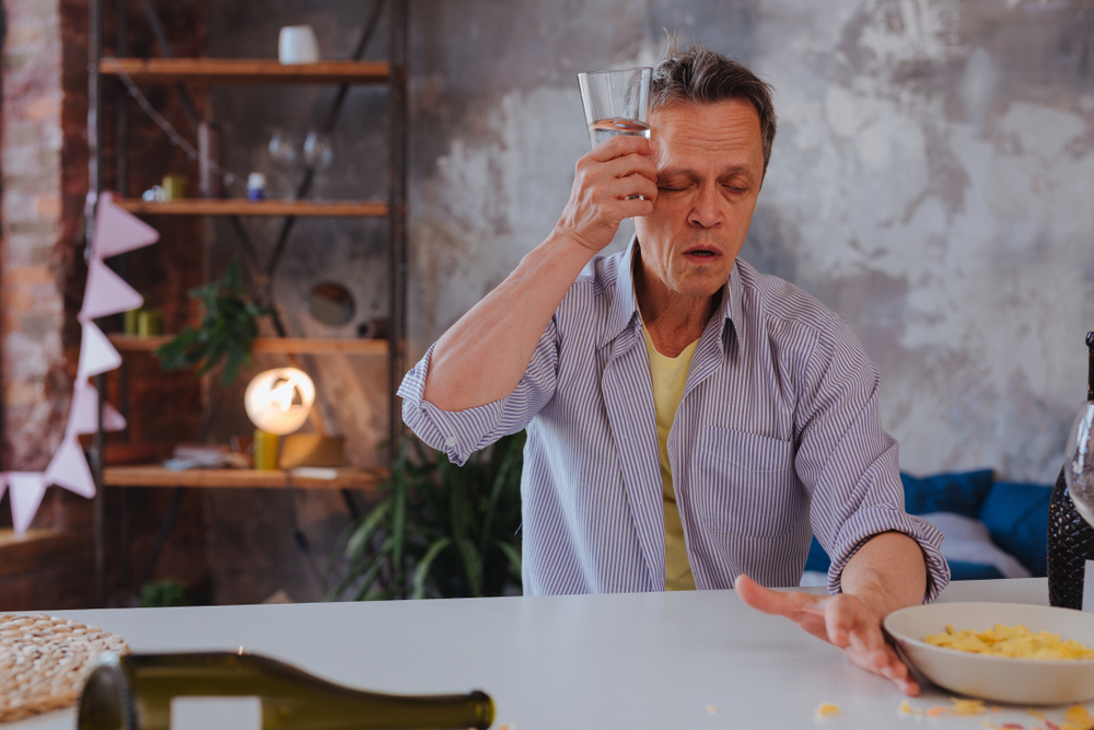 Older unhappy man drinking excessively