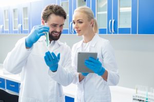 Research team looking at test tube 300x200