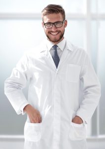 smiling doctor standing in hospital 212x300