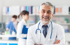 smiling doctor with crossed arms 300x194