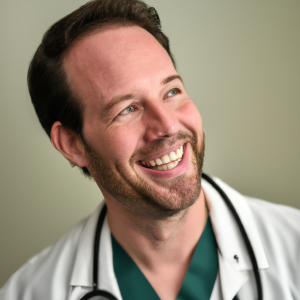 a professional and visually appealing image of a young happy smiling caucasian doctor with white teeth